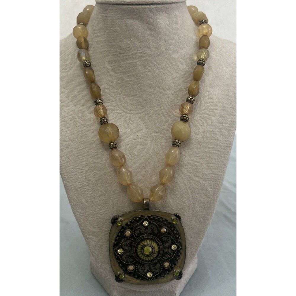 statement necklace featuring a large, ornate square pendant